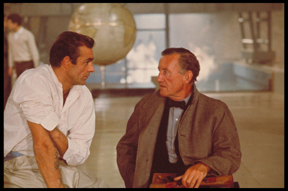 Sean Connery and author Ian Fleming discuss the character of James Bond while filming an interior scene for ‘Dr No’ at Pinewood Studios.