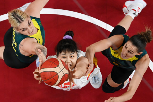 Busy action under the basket between the Opals and China.