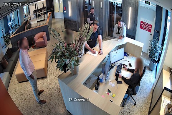 Stills from CCTV played at Melbourne Magistrates’ Court on Wednesday show Jonny “Two Guns” Walker (rear near lifts).