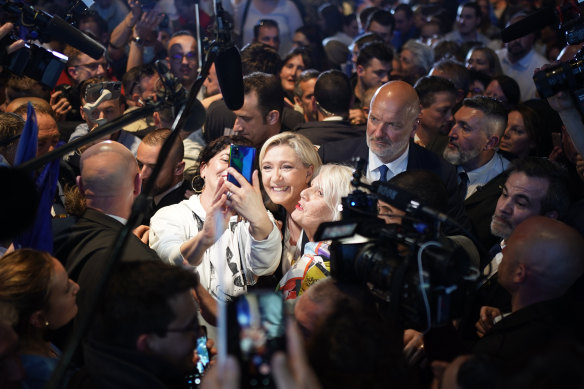 French far-right leader Marine Le Pen, here posing for a selfie with supporters, has been growing in popularity.