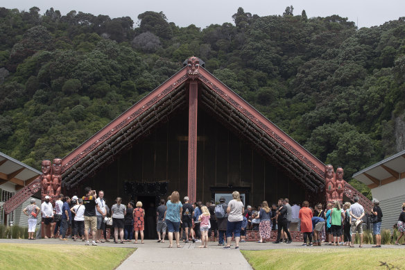 People gather at a community centre in the mainland town of Whakatane, near White Island, to mourn those lost.