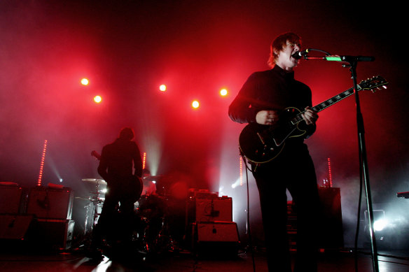 Daniel Kessler on guitar, Sam Fogarino on drums and Paul Banks on vocals and guitar from Interpol playing at the Enmore Theater in 2005.