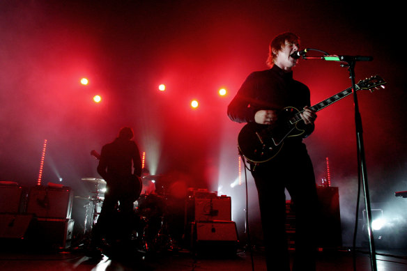  Daniel Kessler on guitar, Sam Fogarino on drums and Paul Banks on vocals and guitar, from Interpol, playing at The Enmore Theatre in 2005.