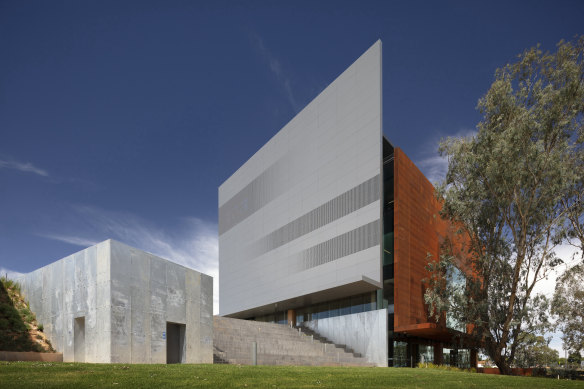 Four blade walls that don’t quite touch are each made with a different material.