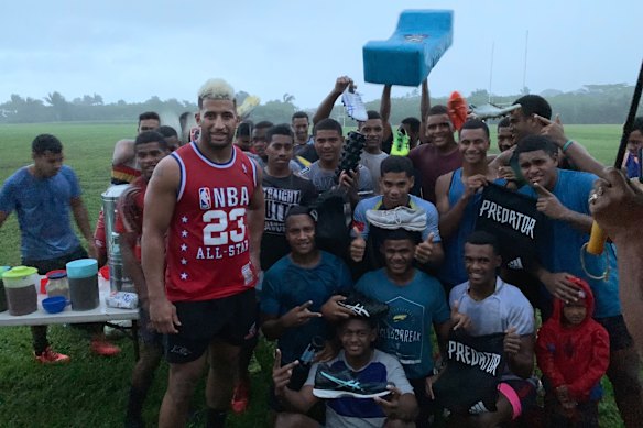 Giving back: Viliame Kikau delivers playing equipment to a rugby club in Fiji during a previous visit.