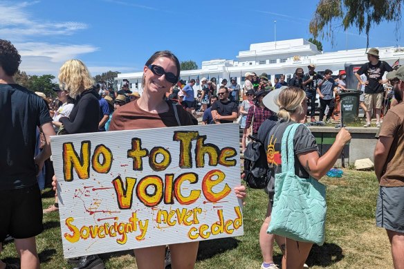 A protester holding a sign at the Canberra Tent Embassy.