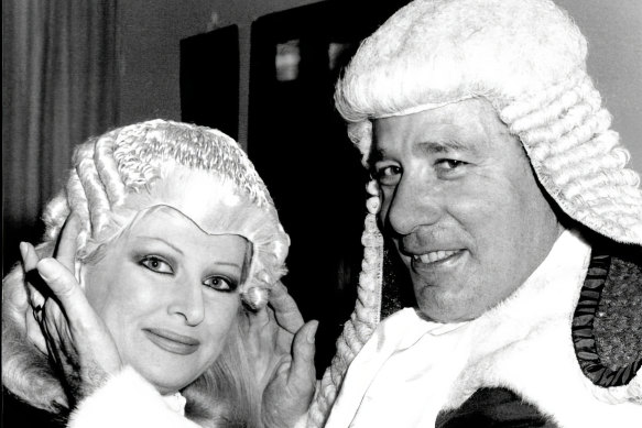 Partners-in-law: Judge Rogers adjusting the wig of his wife Helen Coonan when she was admitted to the Bar in July, 1986.