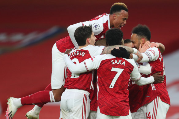 Pierre Emerick Aubameyang (right) celebrates the first of his three goals for Arsenal against Leeds.
