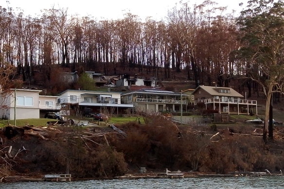 The home of Greg Webb and Alex Smidt, top right, which burned in the South Coast bushfires.