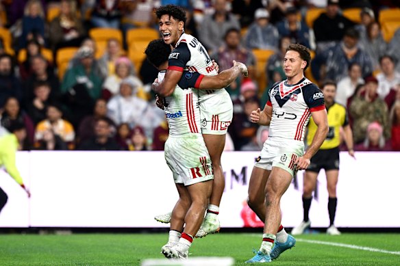 Robert Toia celebrates with teammates after another try for the Roosters.