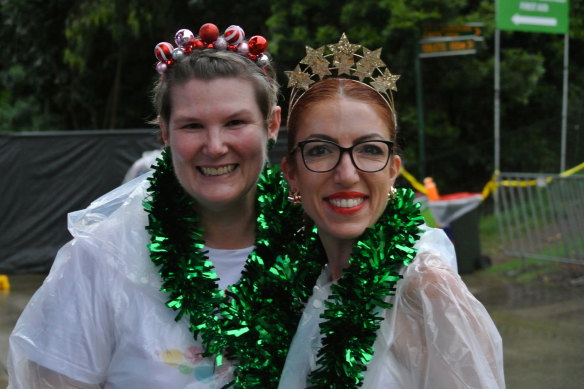 Belinda Edwards and Pip Wright brave the wet weather to attend the Pub Choir Christmas fundraiser.