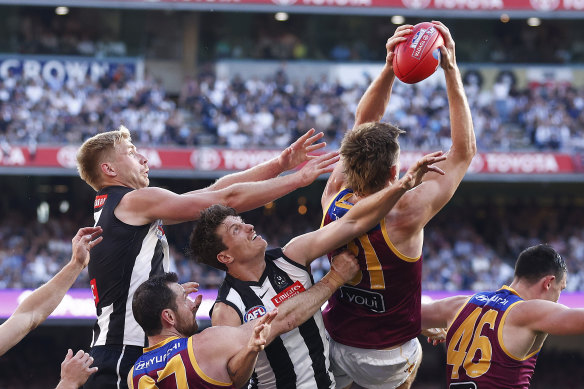 Harris Andrews flies in front of opponent Billy Frampton (rear) reels in a great pack mark for Brisbane.