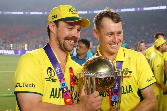 Travis Head and Marnus Labuschagne pose with the World Cup Trophy.