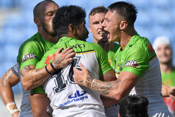 Raiders players embrace Iosia Soliola after his second-half try against the Warriors.