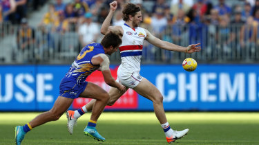 Dishing it up: Bulldog Marcus Bontempelli kicks under pressure from Andrew Gaff.