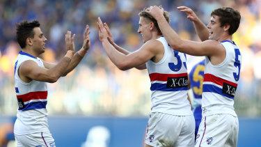 Tails up: Aaron Naughton (centre) puts the Dogs ahead early during the round 11 clash against the Eagles at Optus Stadium in Perth.