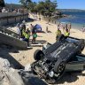 ‘Very scary’: Car smashes through north shore beach wall, flips onto sand