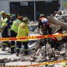 Cars covered by rubble after building collapse in Sydney's inner west