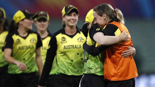 An emotional Ellyse Perry embraces her victorious teammates after their World Cup semi-final win.
