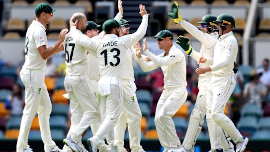 Nathan Lyon and Australia celebrate the wicket of Babar Azam on day four at the Gabba.
