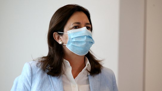 Queensland Premier Annastacia Palaszczuk arrives at her press conference in a face mask. Masks are compulsory in greater Brisbane this weekend.