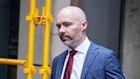 James Mawhinney leaving the Melbourne Magistrates Court on April 9 after being arrested and charged with four counts of engaging in dishonest conduct in the course of carrying on a financial services business. He says he will defend the charges.
