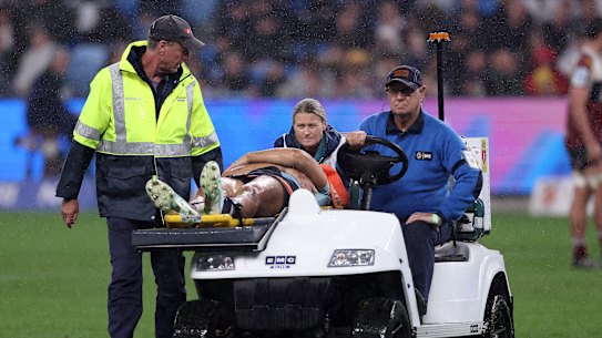 Joseph-Aukuso Suaalii of the NSW Waratahs is taken off the field. 