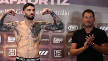 Michael Zerafa poses as Eddie Hearn looks on.