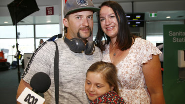 Matt Jacobi meets his wife, Ash, and daughter, Paityn, at Brisbane Airport on Tuesday.