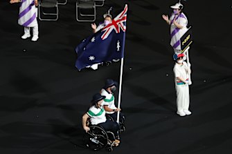 Dani Di Toro and Ryley Batt fly the Australian flag at the Paralympic opening ceremony. 