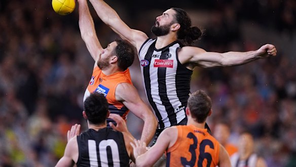 Tough contest: Magpie Brodie Grundy reaches over Shane Mumford.