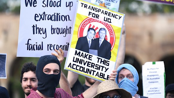 Students hold placards demanding transparency from UQ at Wednesday's protest.
