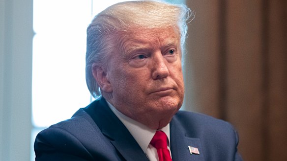 US President Donald Trump listens to updates about the coronavirus in the Cabinet Room of the White House.