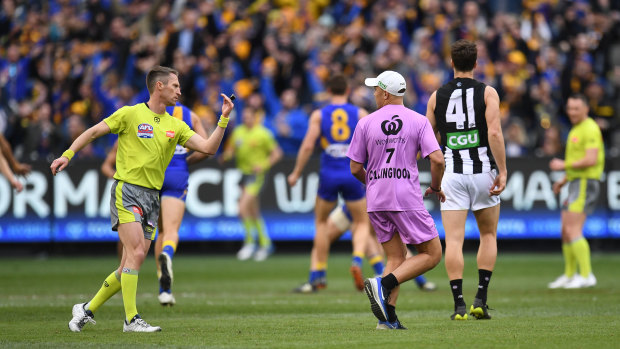 Wayward: Magpies runner Alex Woodward (in pink) after blocking Jaidyn Stephenson during a critical build-up play in the grand final.