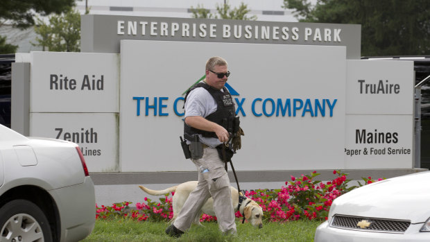 A sniffer dog searches the industrial complex where the shooting occurred.