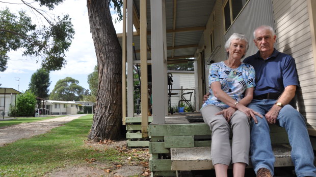 Canberra couple Elizabeth and Robin Turnbull outside their cabin, which they will soon be forced to remove from Tomaga River Holiday Park if a proposed redevelopment goes ahead.