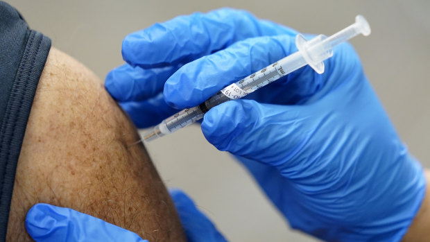 A healthcare worker receives a second Pfizer-BioNTech COVID-19 vaccine,