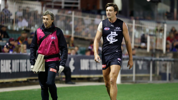 Hobbling off: Carlton's Caleb Marchbank leaves the field after suffering an injury.
