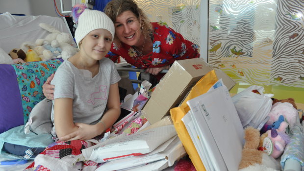 Tess Egginton with her mum Stephanie and the delivery of Warrior Mail at Perth Children's Hospital. 