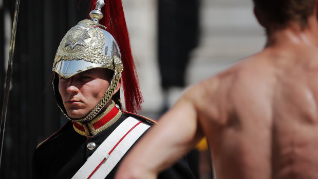 A member of the Queen's Lifeguard marches at Horse guards Parade as temperatures reached nearly 40 degrees in London.