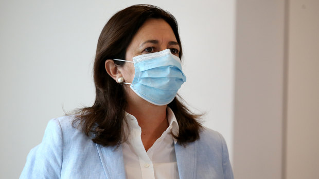 Queensland Premier Annastacia Palaszczuk arrives at her press conference in a face mask. Masks are compulsory in greater Brisbane this weekend.