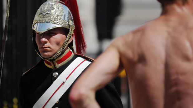 A member of the Queen's Lifeguard marches at Horse Guards Parade as temperatures rose far above 30 degrees in London.