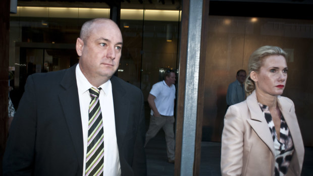 Robert Comiskey leaves with his wife, Carla, after giving evidence at the Crime and Corruption Commission in 2017.