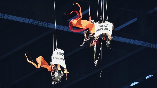 Greenpeace protesters hang off the Sydney Harbour Bridge on Tuesday morning.