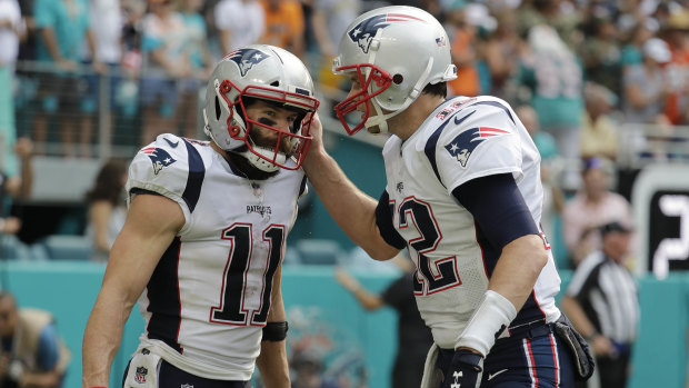 Patriots quarterback Tom Brady (right) congratulates Julian Edelman after the record-setting touchdown.