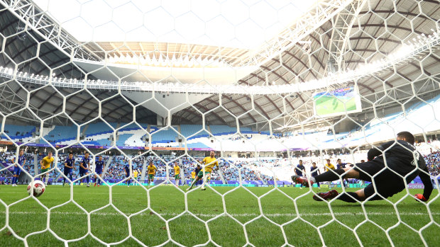 Martin Boyle scores Australia’s first goal from the penalty spot past Utkir Yusupov of Uzbekistan.