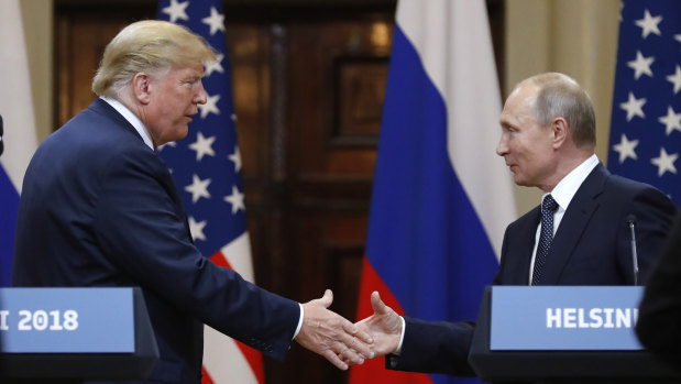 Donald Trump shakes hands with Vladimir Putin in Helsinki.