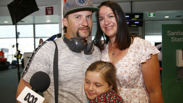 Matt Jacobi meets his wife, Ash, and daughter, Paityn, at Brisbane Airport on Tuesday.
