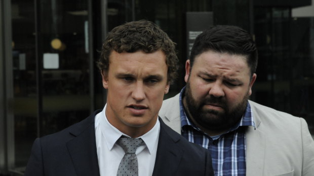 Canberra Raiders fullback Jack Wighton (left), supported by former NRL player George Rose apologises for his behaviour outside ACT courts on Wednesday.