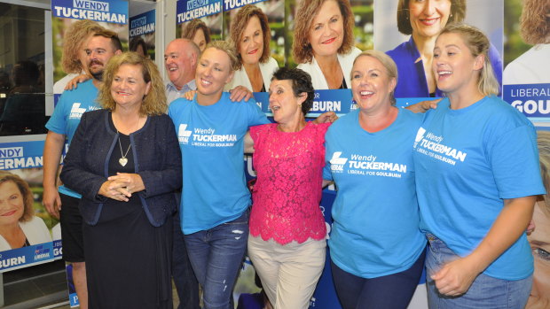 Liberal Party candidate for Goulburn Wendy Tuckerman (front left), Pru Goward (centre) and staffers celebrate at their campaign office on Saturday night.